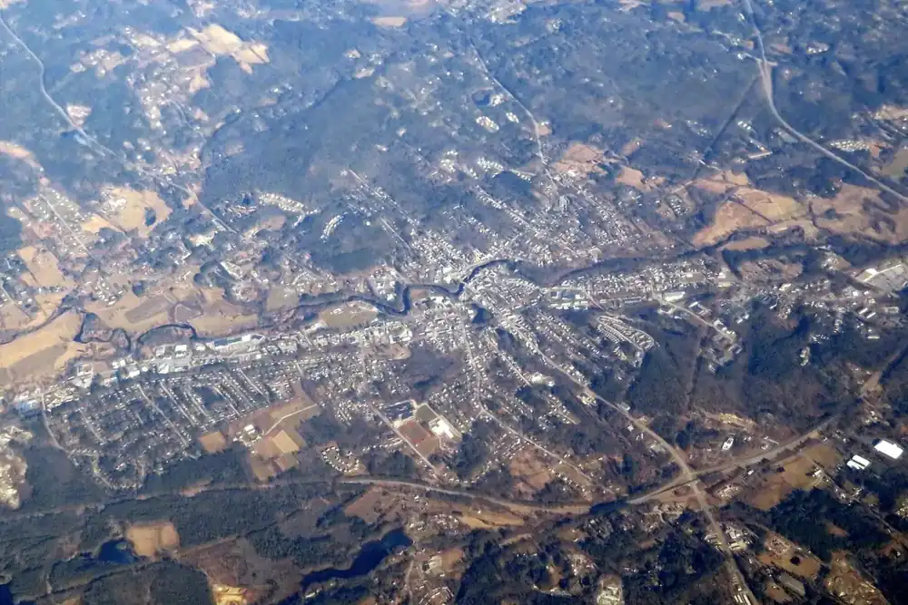 Aerial view of Milford, New Hampshire, its town center and surrounding forest in winter