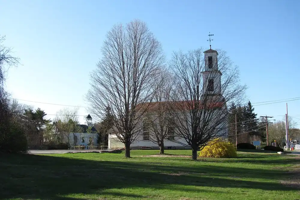 The First Parish Meeting House with its bell tower behind a lawn in Tyngsborough