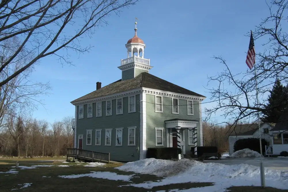 The old Westford Academy building with its cupola beside the town common in Westford